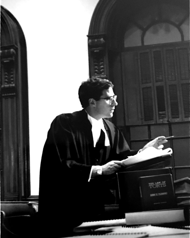 Timothy S.B. Danson as a young barrister, in robes, arguing in a courtroom at Osgoode Hall